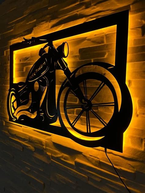 A Bike Mounted To The Side Of A Brick Wall With Yellow Light Coming From It