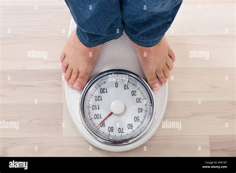 Low Section Of A Person Standing On Weighing Scale Stock Photo Alamy