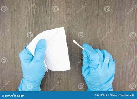 Man Wear Latex Gloves Holding Cotton Bud And Tissue Paper Stock Image