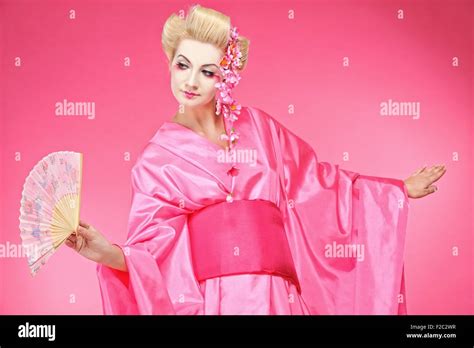 Beautiful geisha dancing with a fan Stock Photo - Alamy