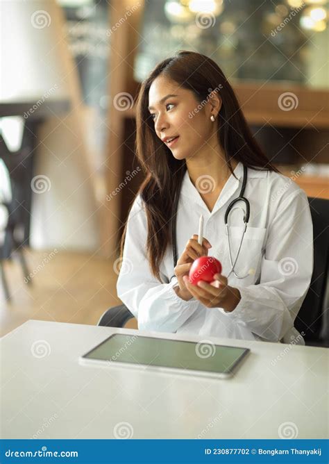 Portrait Of A Beautiful Female Doctor Or Physician Wearing A White Gown