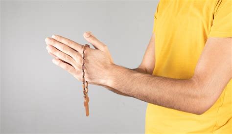 Premium Photo Man Holding A Cross In His Hand