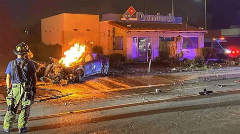 Car Catches Fire After Crashing Into Dominos