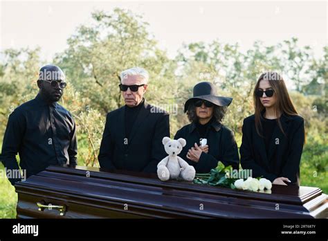Group Of Grieving Intercultural People In Mourning Clothes Gathered By