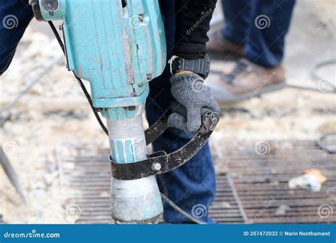 Male Workers Use Electric Concrete Breaker For Digging And Drilling