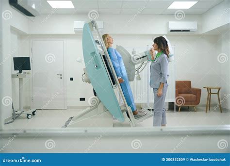 Experienced Radiologic Technologist Preparing Adult Female For