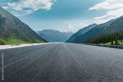 Straight asphalt road and mountain under blue sky. Highway and mountain ...