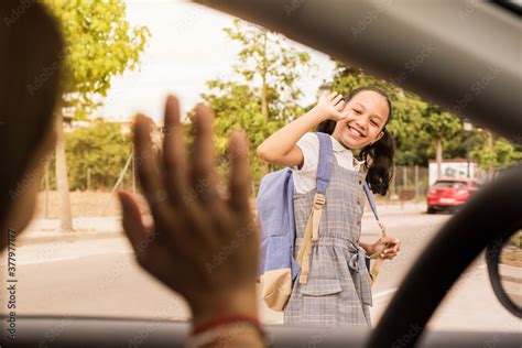 View From The Car Schoolgirl Saying Goodbye With The Hand Smiling