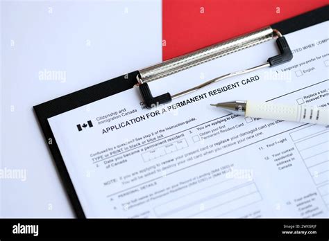 Application For Permanent Resident Card On Table With Pen Close Up