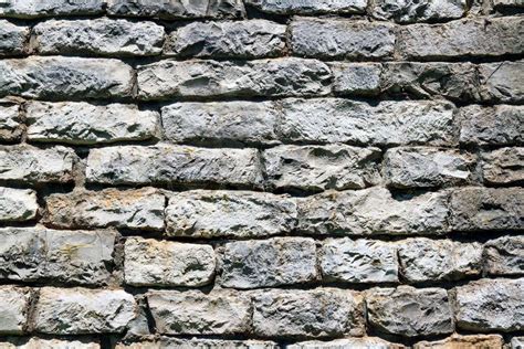 A rustic limestone block wall shows weathered texture. | Stock Photo | Colourbox