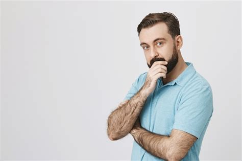 Free Photo Curious Bearded Man Making Decision Thinking And Look