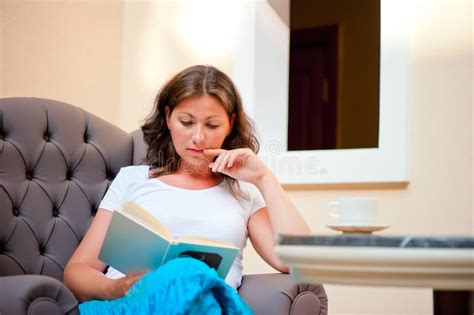 Brunette Sitting In A Chair And Reading A Book Stock Photo Image Of Life Book