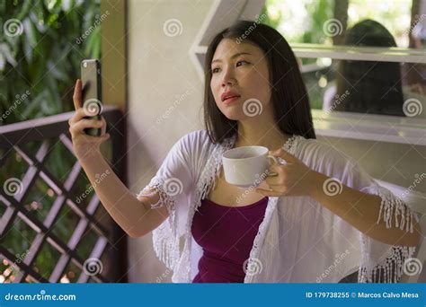 Young Beautiful And Happy Asian Chinese Woman Having Morning Coffee