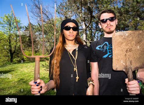 Couple Holding Pitchfork And Spade Portrait Stock Photo Alamy