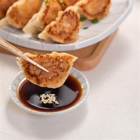 Premium Photo Panfried Gyoza Dumpling Jiaozi In A Plate With Soy