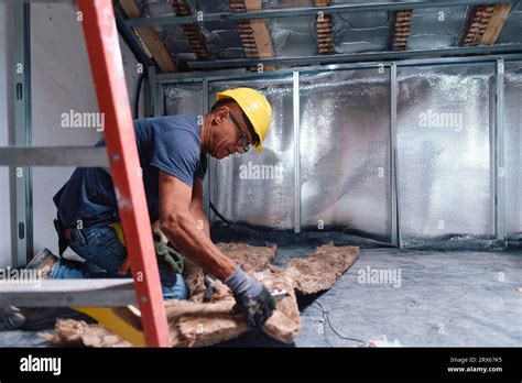 Mature Construction Worker Working On Insulation At Site Stock Photo