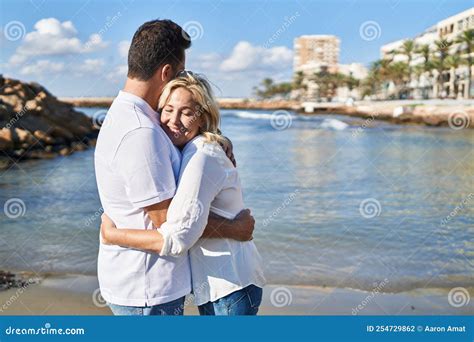 Middle Age Man And Woman Couple Hugging Each Other Standing At Seaside