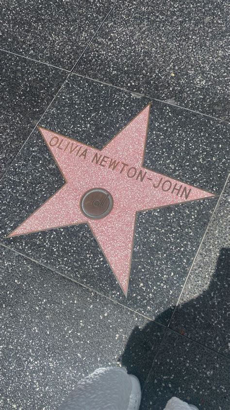 a star on the hollywood walk of fame with someone standing next to it and their feet