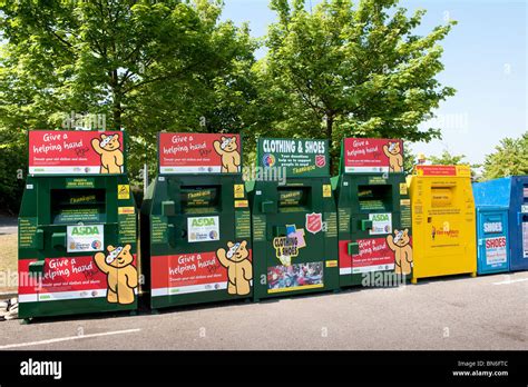 Row Of Clothing Recycling Bins In An Asda Supermarket Car Park Stock