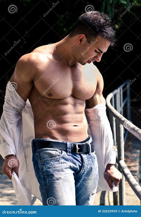 Attractive Bodybuilder With Open Shirt Showing Torso Muscles Stock