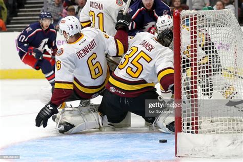 The Puck Is Loose In Front Of The Goal Behind Chicago Wolves News