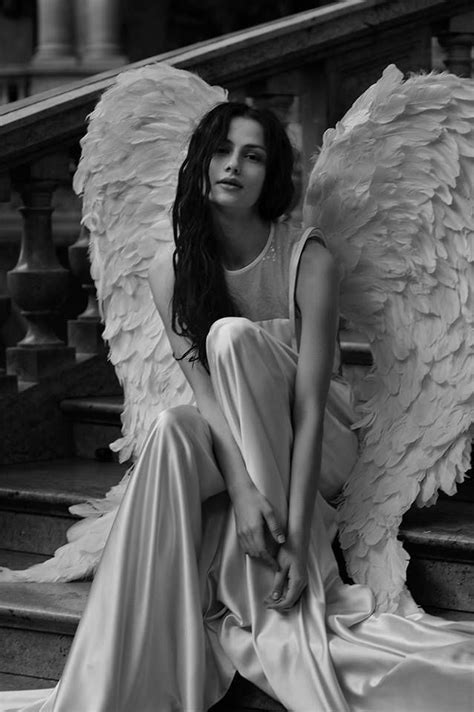 Black And White Photograph Of A Woman Sitting On Stairs With Angel