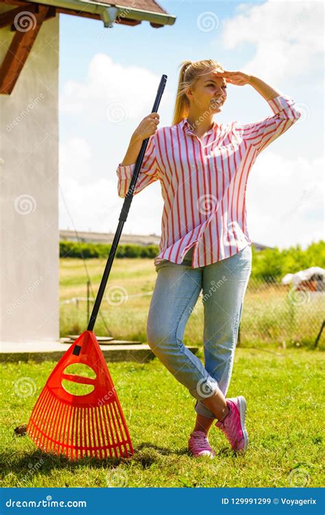 Woman Using Rake To Clean Up Garden Stock Image Image Of Orange