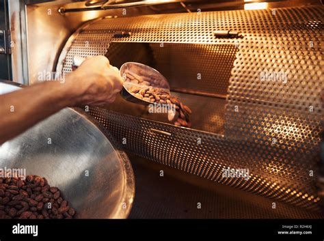 Worker in a chocolate making factory roasting cocoa beans Stock Photo - Alamy