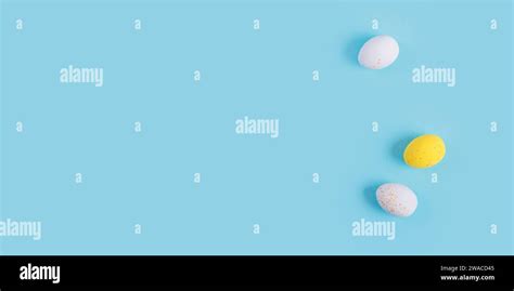 Minimalistic easter background of chocolate candy yellow and white eggs ...