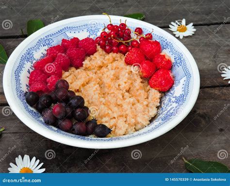 Bowl Of Oatmeal Porridge With Fresh Strawberries And Raspberries