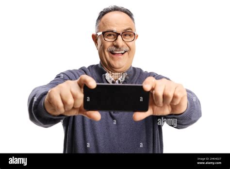 Smiling Mature Man Taking A Photo With A Smartphone Camera Isolated On White Background Stock