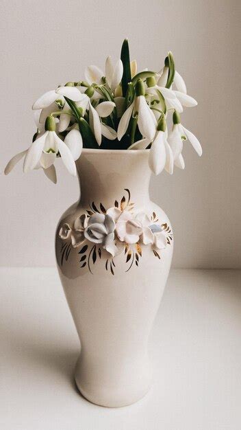 Premium Photo Snowdrops In A White Vase The First Spring Flower