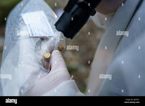 Close Up On Hands Of Unknown Man Forensic Police Investigator