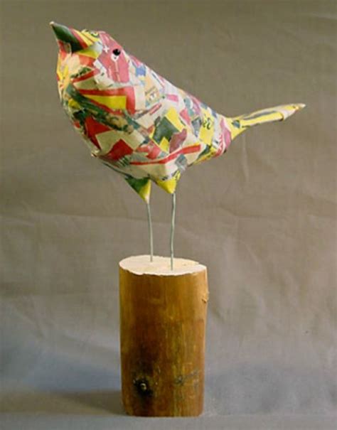 A Colorful Bird Sitting On Top Of A Wooden Stump Next To A White Wall