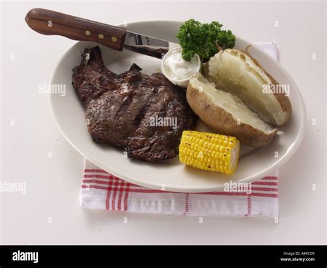 Boneless Ribeye Steak With Baked Potato Sour Cream Stock Photo Alamy