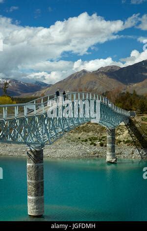 The Lake Tekapo Foot Bridge Over The Scott Pond Connecting The Church