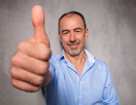 Old Man Posing In Studio Background Showing The Ok Sign Stock Photo