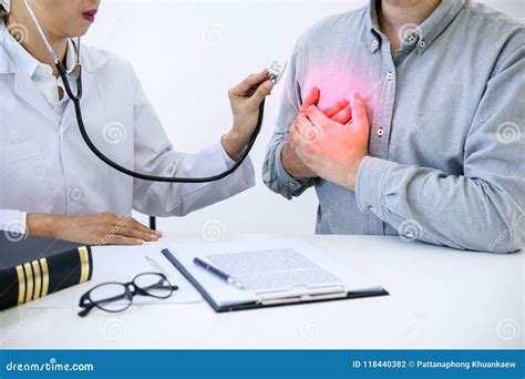 Female Doctor Checking Heart Beat Of Patient And Recommend Treat Stock