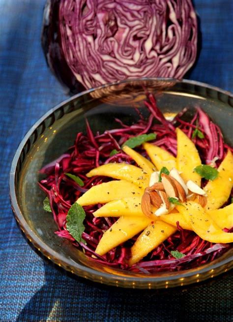 A Bowl Filled With Red Cabbage And Mango Slices