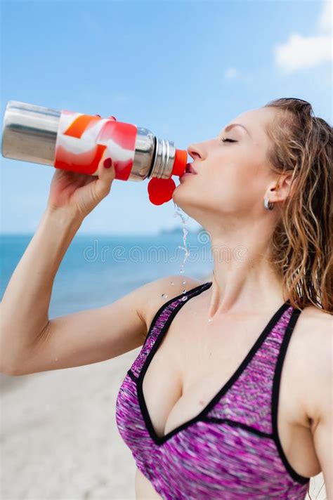 Fitness Beautiful Woman Drinking Water And Sweating After Exercising On Summer Hot Day In Beach