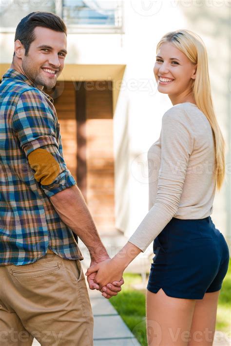 Walking Together Happy Young Couple Holding Hands And Smiling While