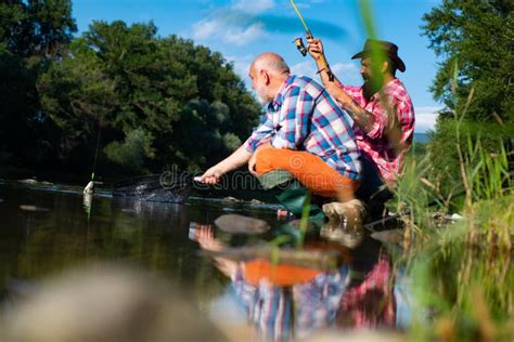 Two Men Friends Fisherman Fishing On River Old Father And Son With Rod