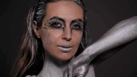 Close-up of a Female Model with Silver Skin and Hands on a Black ...