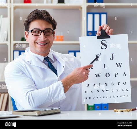 Doctor Optician With Letter Chart Conducting An Ey Hi Res Stock