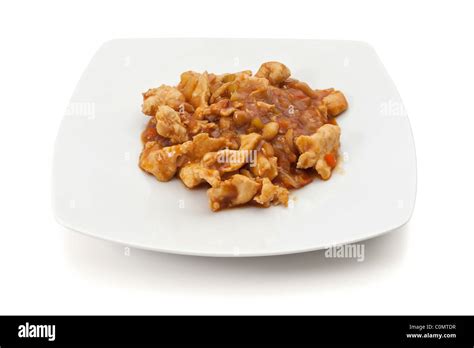 Plate With Chicken In Hot Sauce Isolated On White Background With Clipping Path Stock Photo Alamy