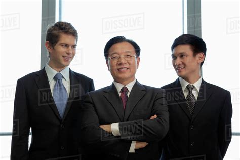 Three Businessmen Standing Together Stock Photo Dissolve