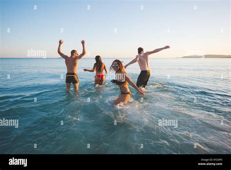 Groupe De Jeunes Amis Multiethnique Les Femmes Et Les Hommes La Plage