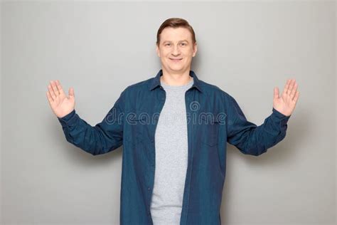 Portrait Of Happy Mature Man Showing Large Size Of Something Stock