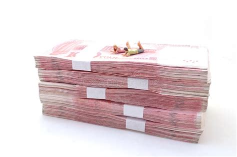 The Couple Lying On Stacks Of Chinese Yuan Banknotes Stock Photo