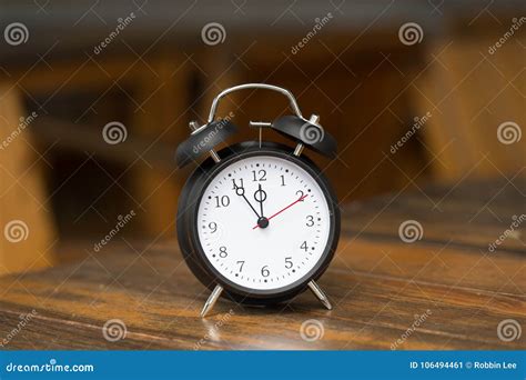 Retro Alarm Clock With Five Minutes To Twelve O Clock Stock Image